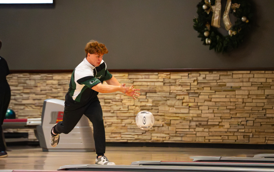 Boy throwing bowling ball